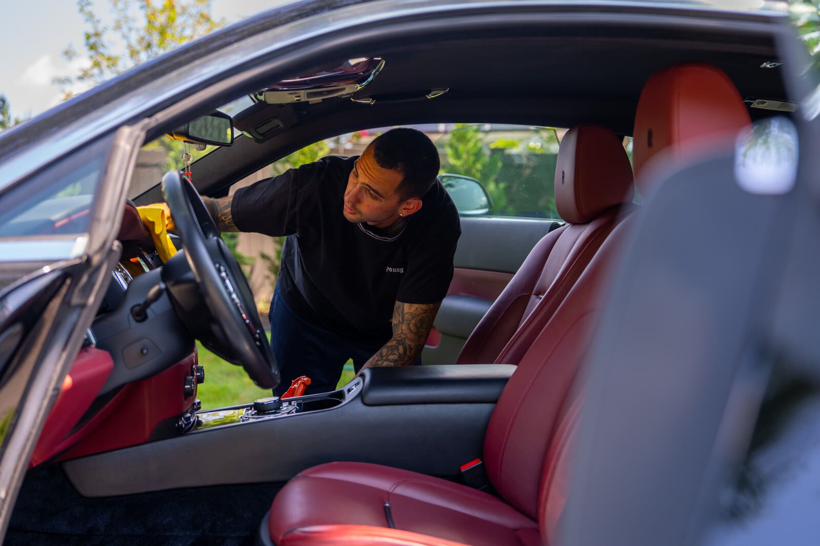 Wide view of the Rolls-Royce Wraith cabin with driver door open during interior work