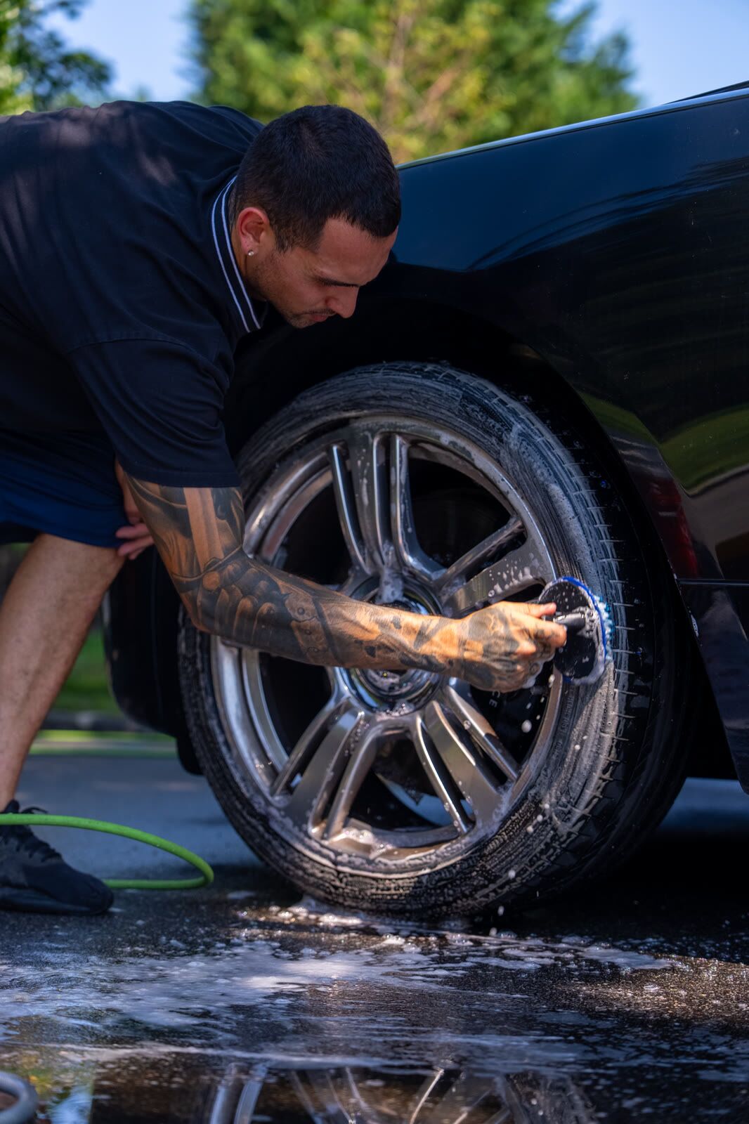 Chrome-spoke Rolls-Royce Wraith wheel after cleaning, brake caliper visible